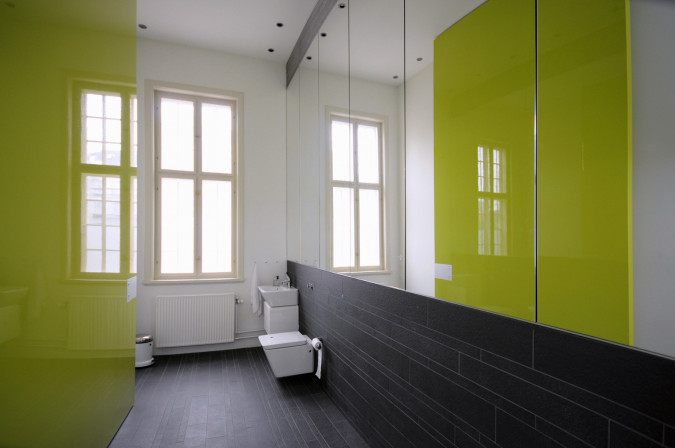 Using the toilets is an experience with the oversized doors painted in remarkable colors.